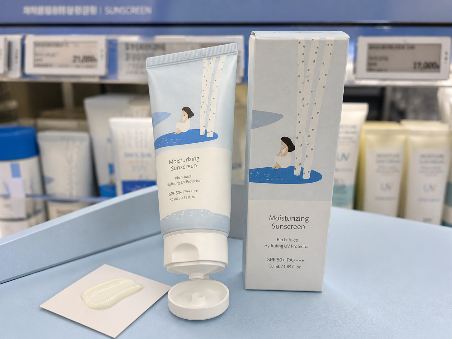 AI-assisted editorial visualization of a generic birch-inspired moisturizing sunscreen in a Korean beauty store · product detail